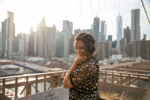 woman celebrating a birthday in New York City with a private photoshoot on the Brooklyn Bridge