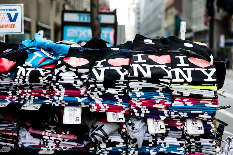 stack of I Love NY t-shirts on an outdoor table