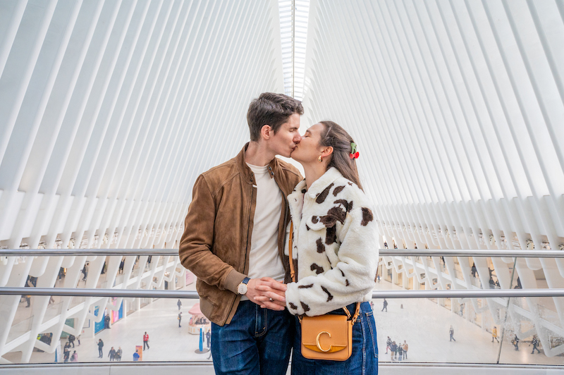 couple taking NYC engagement photos in The Oculus