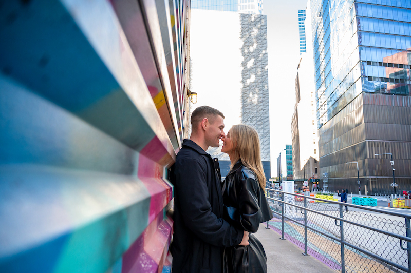 couple taking engagement photos in NYC at the World Trade Center