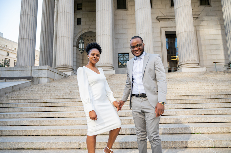 couple taking engagement photos in NYC on the courthouse steps