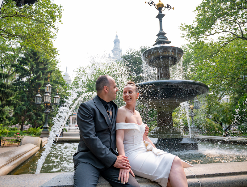 couple posing for NYC engagement photography in City Hall Park