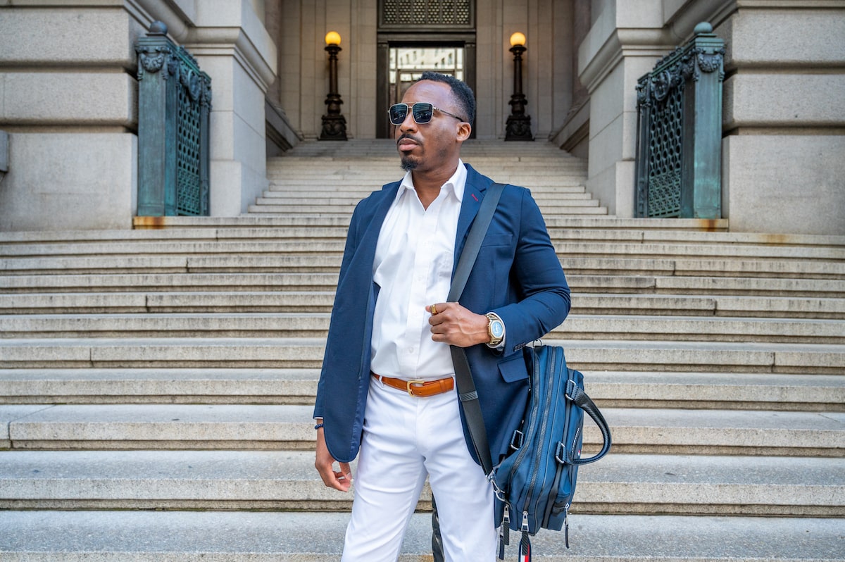 influencer posing with briefcase and watch in Lower Manhattan on a photoshoot